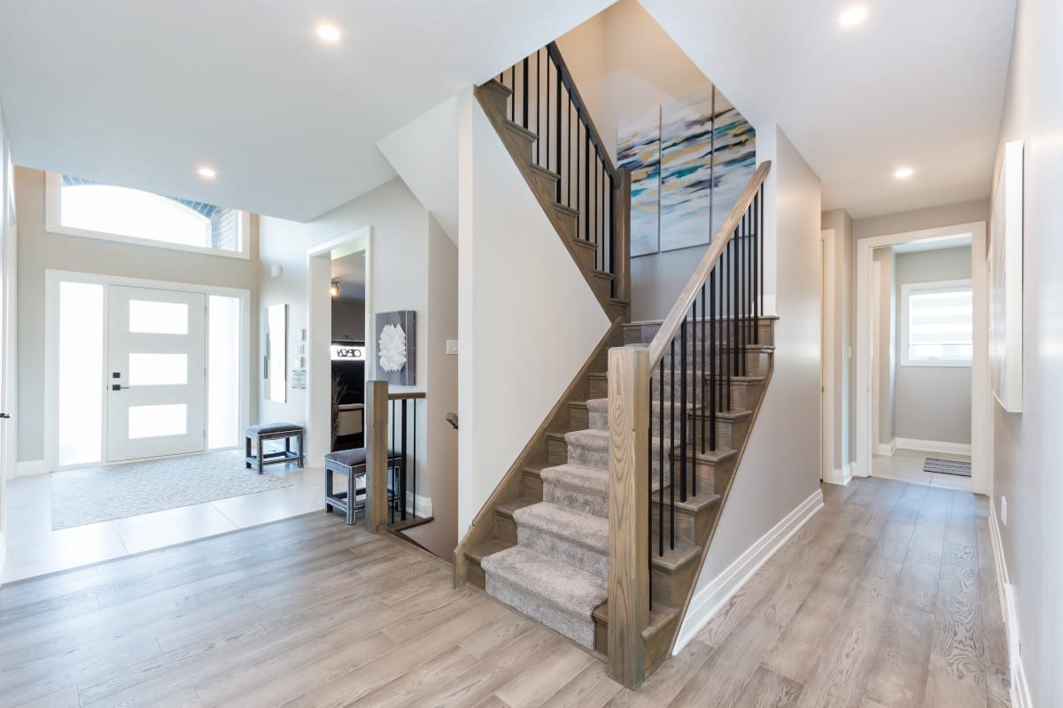 Central staircase in the bright, open concept main floor of a Meadowlily home.
