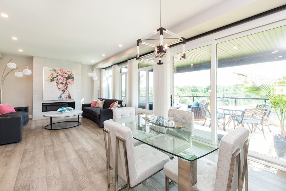 View from the dining area of the covered patio, which offers privacy, with a beautiful view of Meadowlily Homes woods.