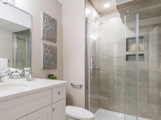 Spacious finished basement bathroom with tiled shower surround at Rembrandt Walk.